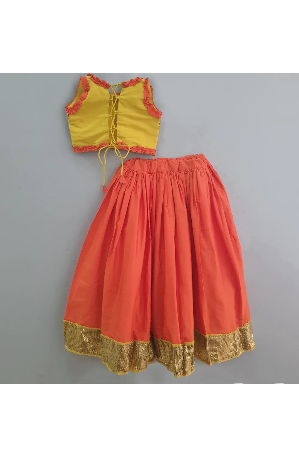 Yellow embroidered top with rust orange ghagra