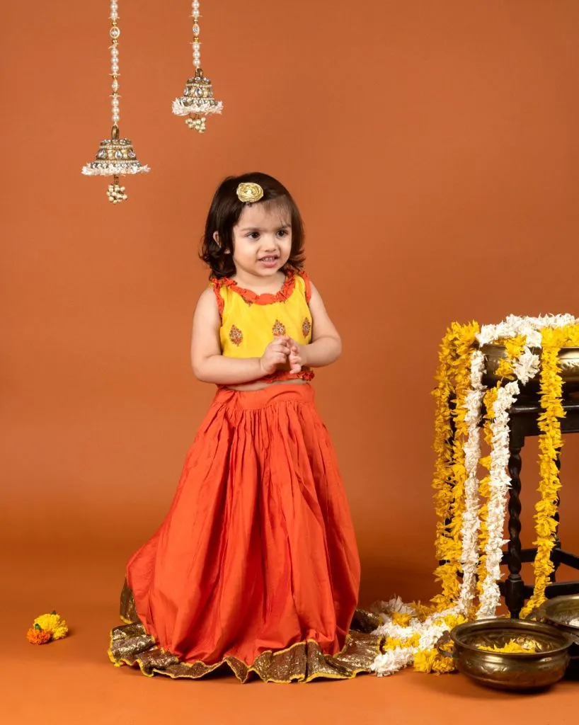 Yellow embroidered top with rust orange ghagra