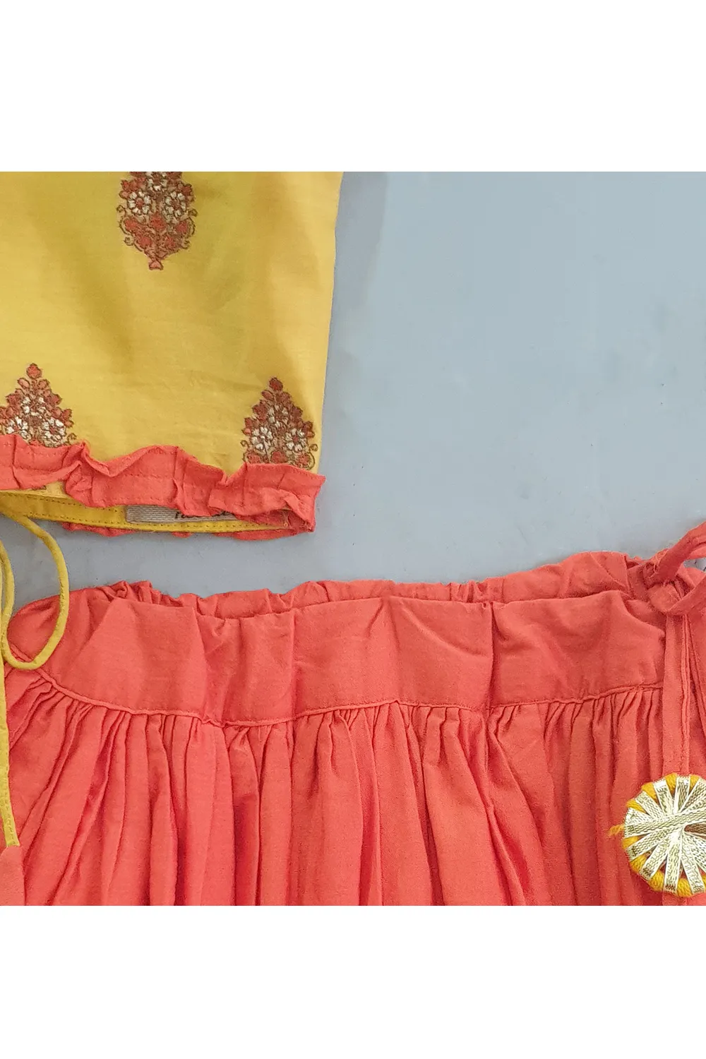 Yellow embroidered top with rust orange ghagra
